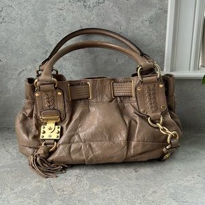 Juicy Couture creamy leather handbag with brass details.